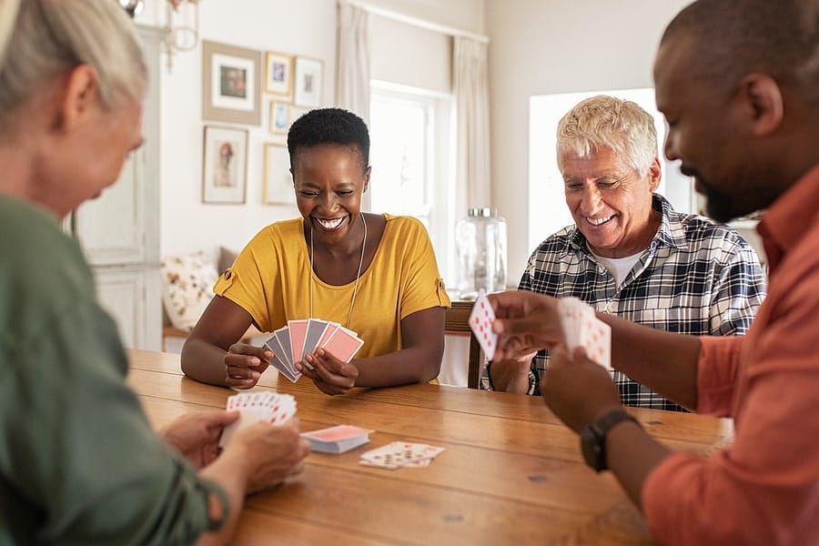 Residents enjoying a card game in a common area