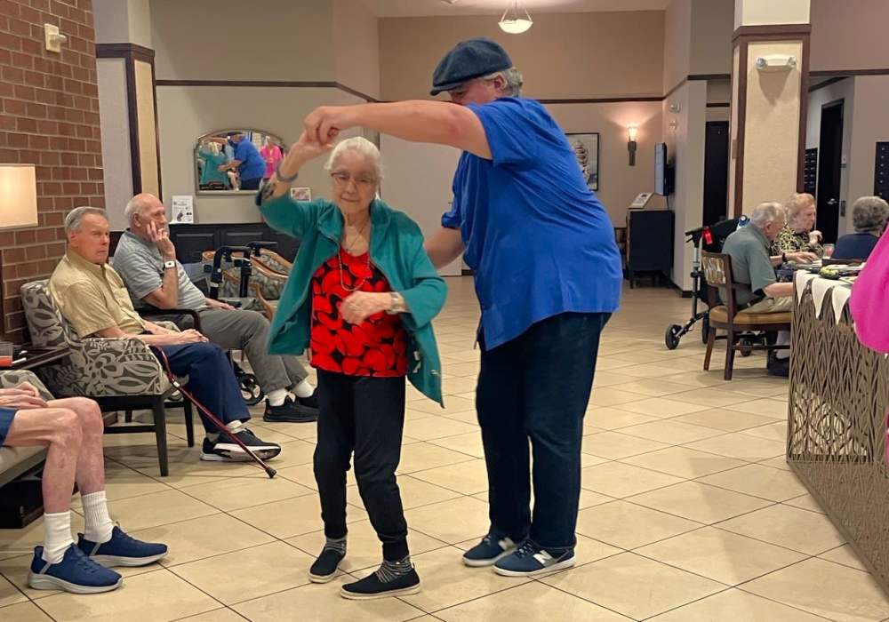 Seniors enjoying a dance in a common area.