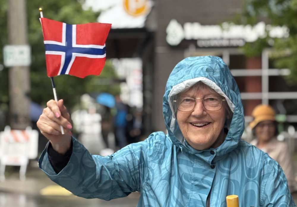 Elderly woman celebrating with a Norwegian flag
