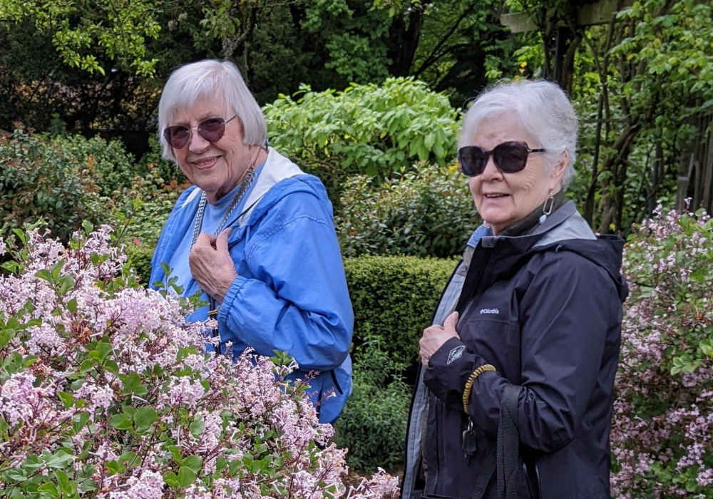 Two senior women enjoying a garden