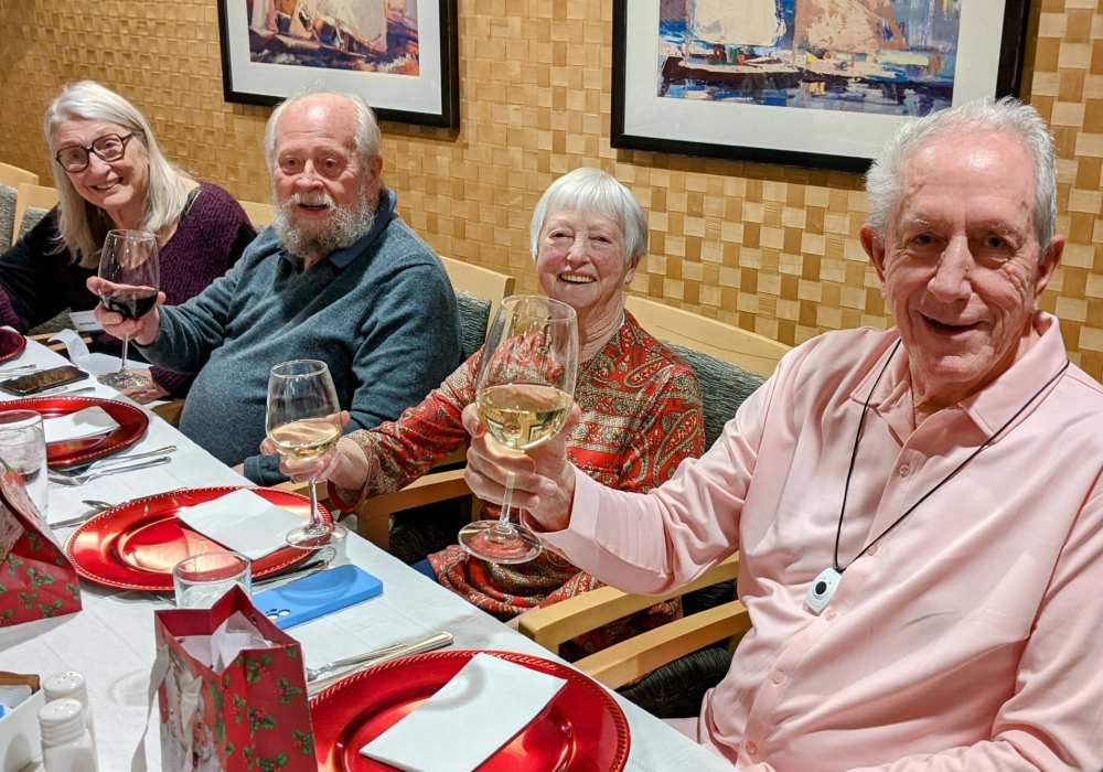 Residents enjoying a toast at a dining table