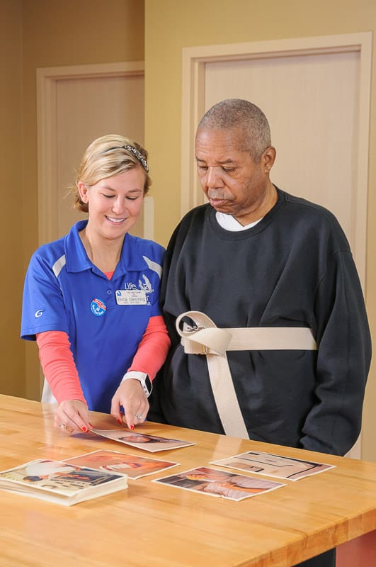Staff member assisting a resident with activities