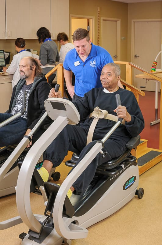 Residents participating in a fitness activity with staff support