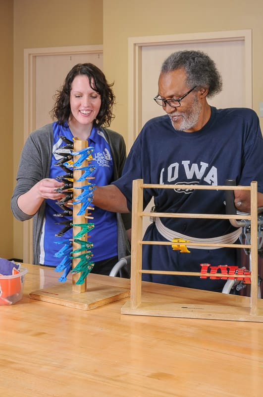 Resident engaging in activity with staff member