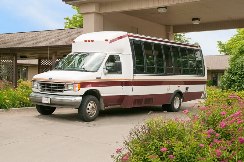 Facility transport van near flowering plants