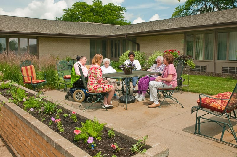 Residents enjoying a sunny day in an outdoor space