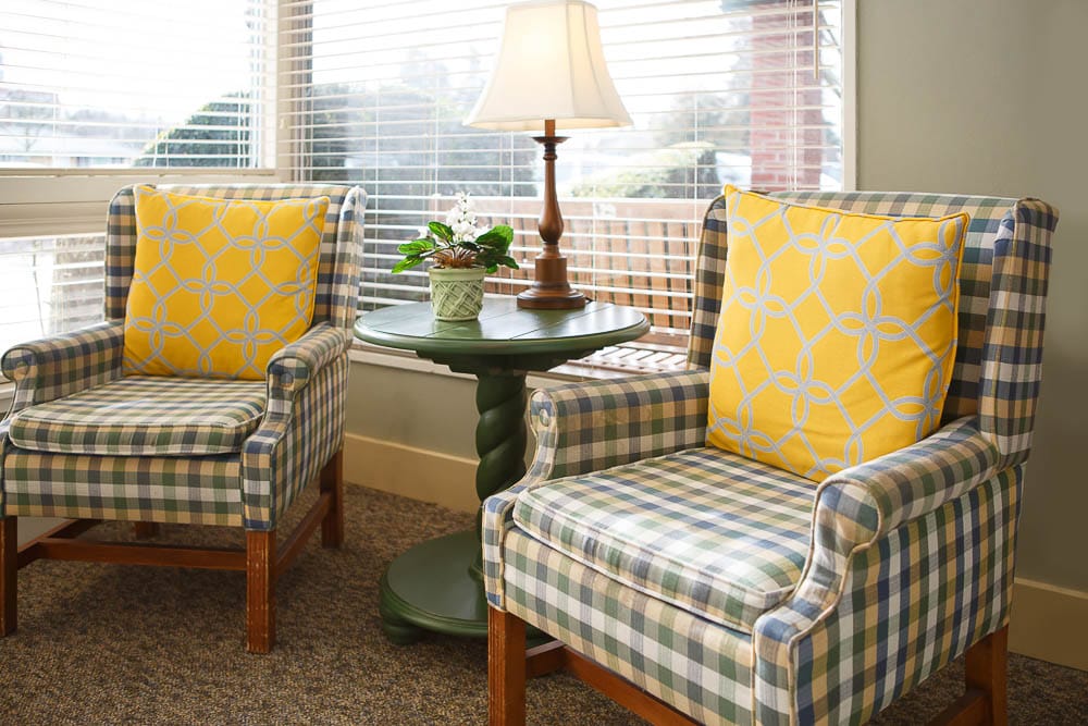 Cozy seating area with patterned chairs and lamp