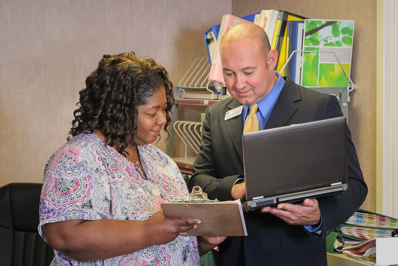 Staff member discussing with a resident in an office