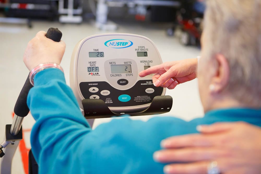 Resident exercising on a NuStep machine