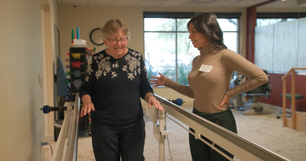 Therapist assisting resident during rehabilitation session