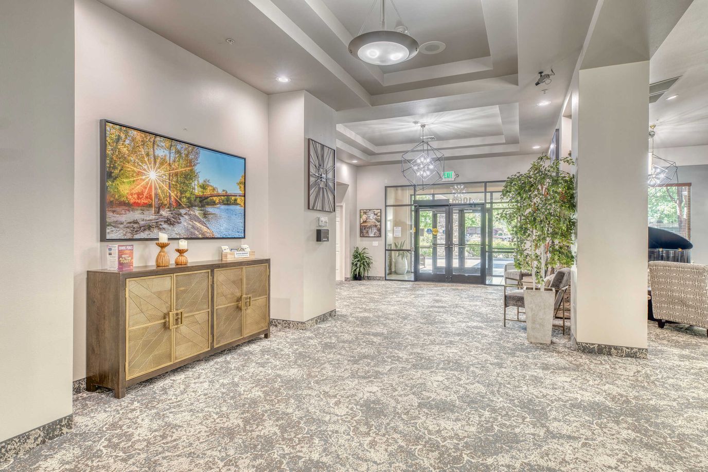 Bright lobby area with decorative elements and a large TV