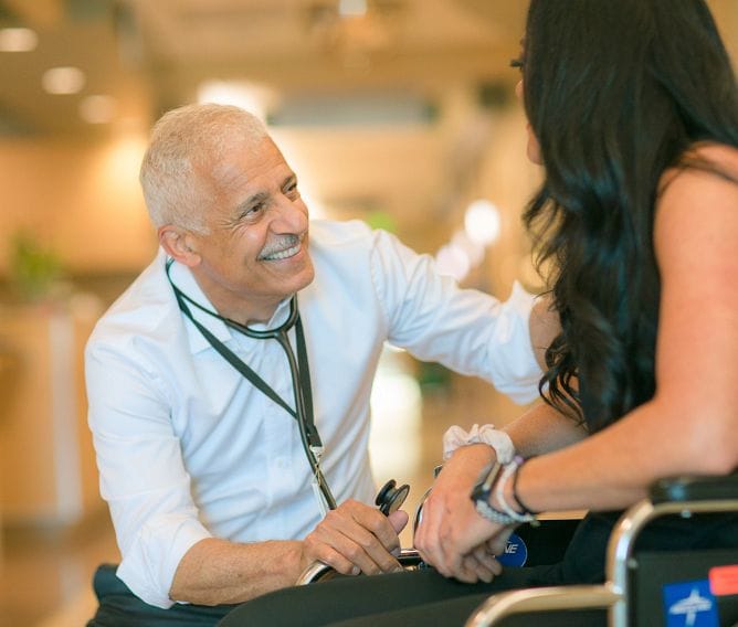 Staff member interacting with a resident in a welcoming interior