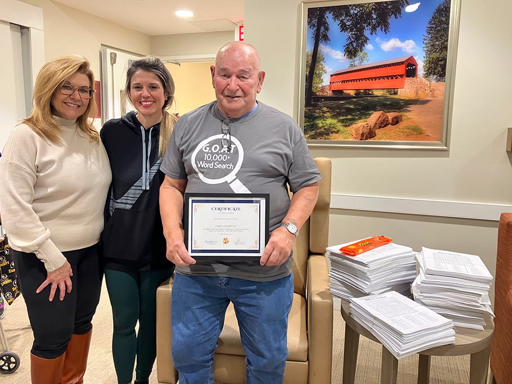 Residents and staff celebrating a certificate achievement.