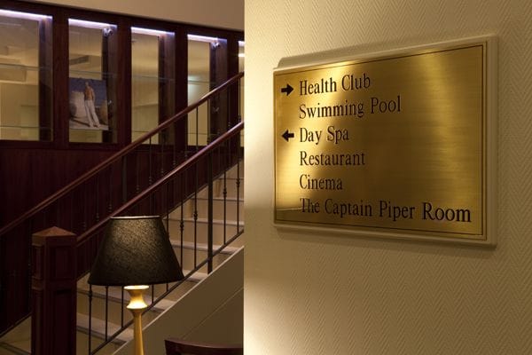 Interior sign directing to amenities like health club and dining