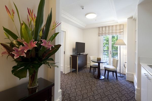 A bright interior room with flowers and seating area