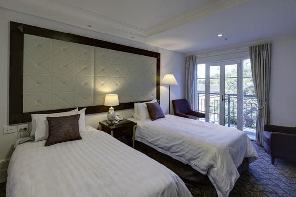 Brightly lit private resident room with two beds