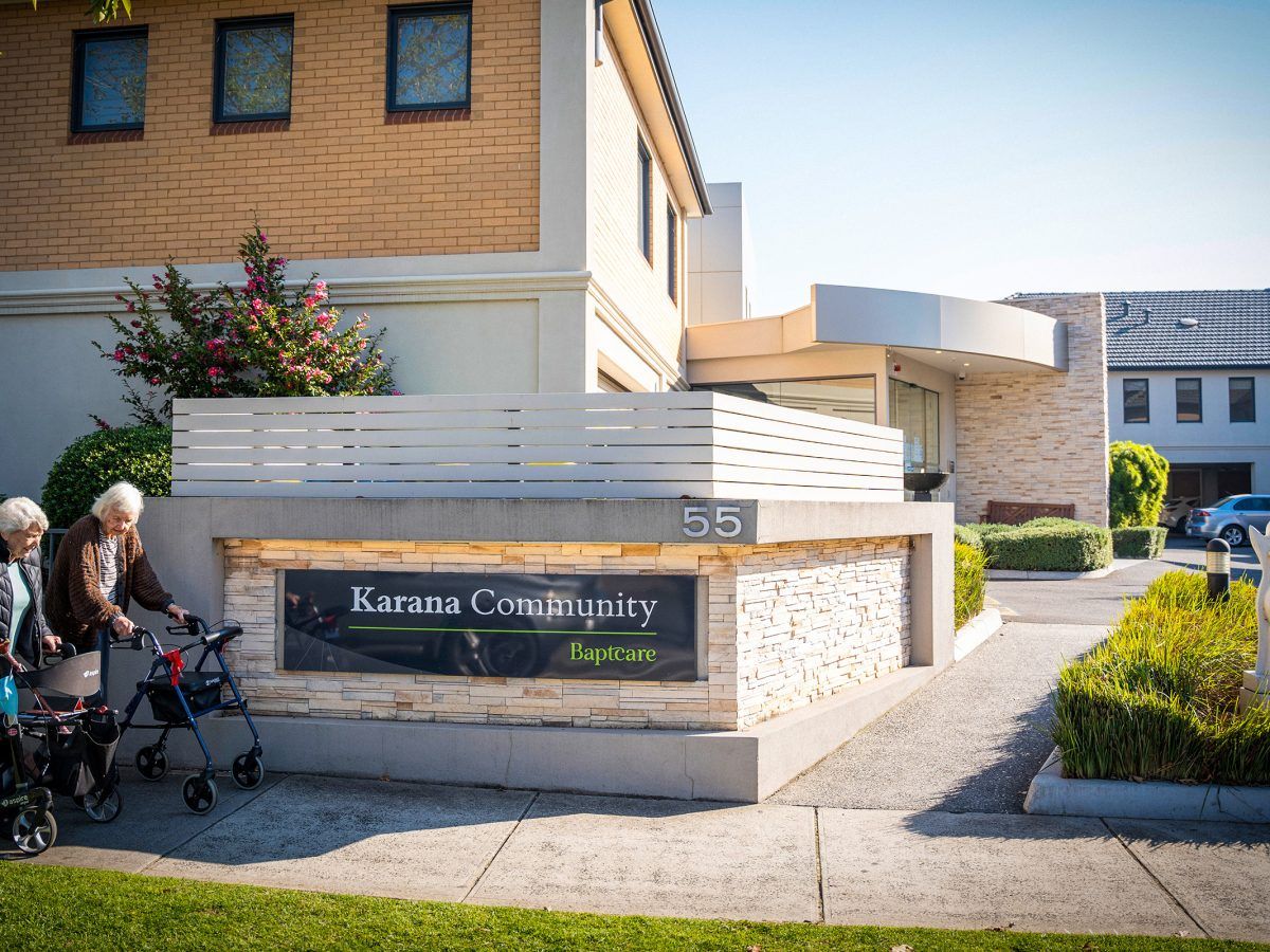 Building exterior with residents near entrance