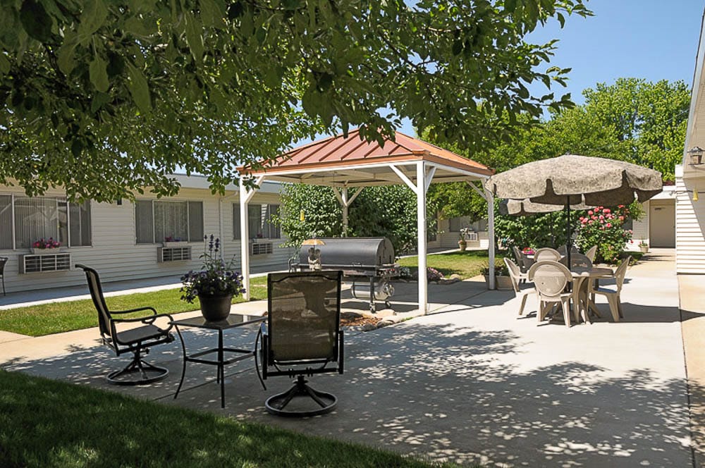 Outdoor seating area with gazebo in a senior living facility