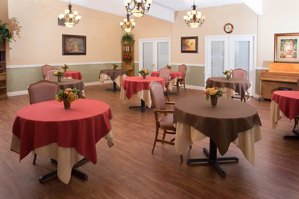 Bright dining area with tables and floral centerpieces