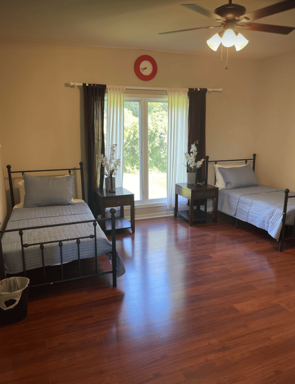 Well-furnished shared resident room with natural light.