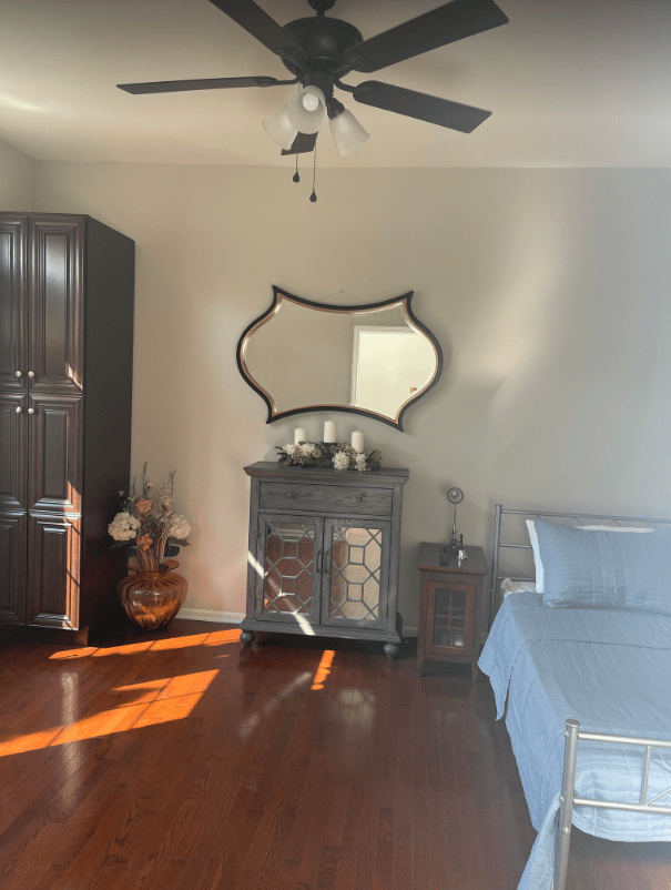 Cozy resident room with wood flooring and decor.