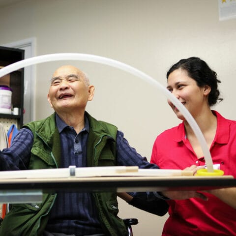 Resident engaging in activity with staff member