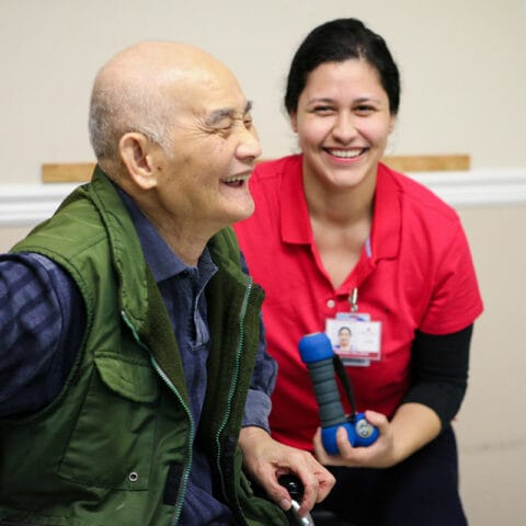 Senior resident and staff member engaging in activity