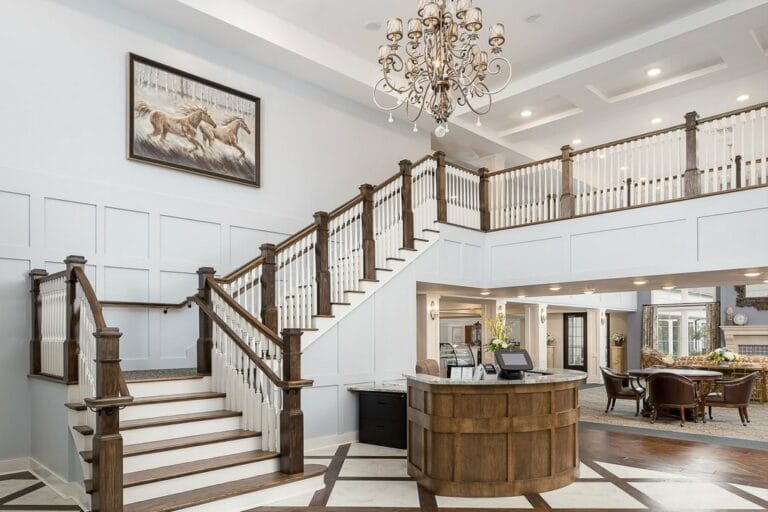 Bright, spacious lobby with staircase and reception area.