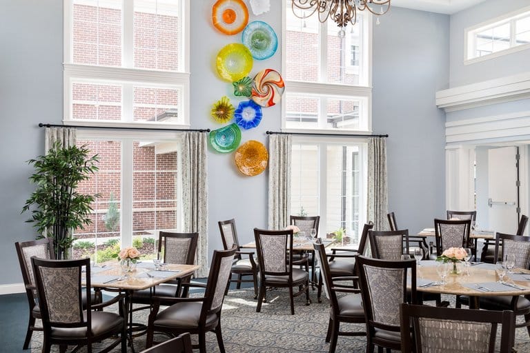 Bright dining room with decorative wall art and tables set for meals