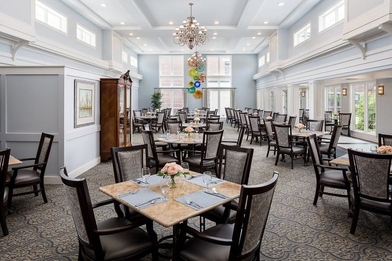 Elegant dining room setup with tables and flowers