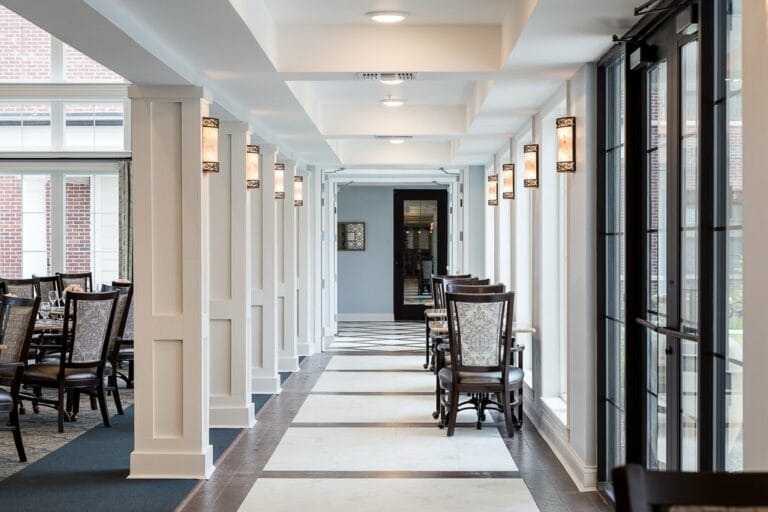 Interior hallway with seating and lighting fixtures