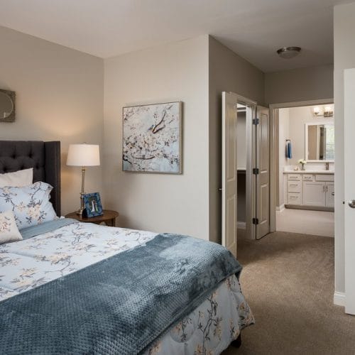 Cozy resident room with bed and bathroom entrance