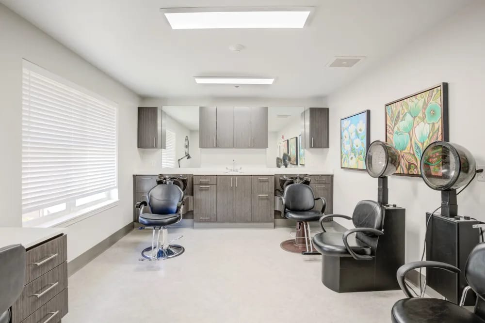 Well-equipped hair salon with styling chairs and artwork