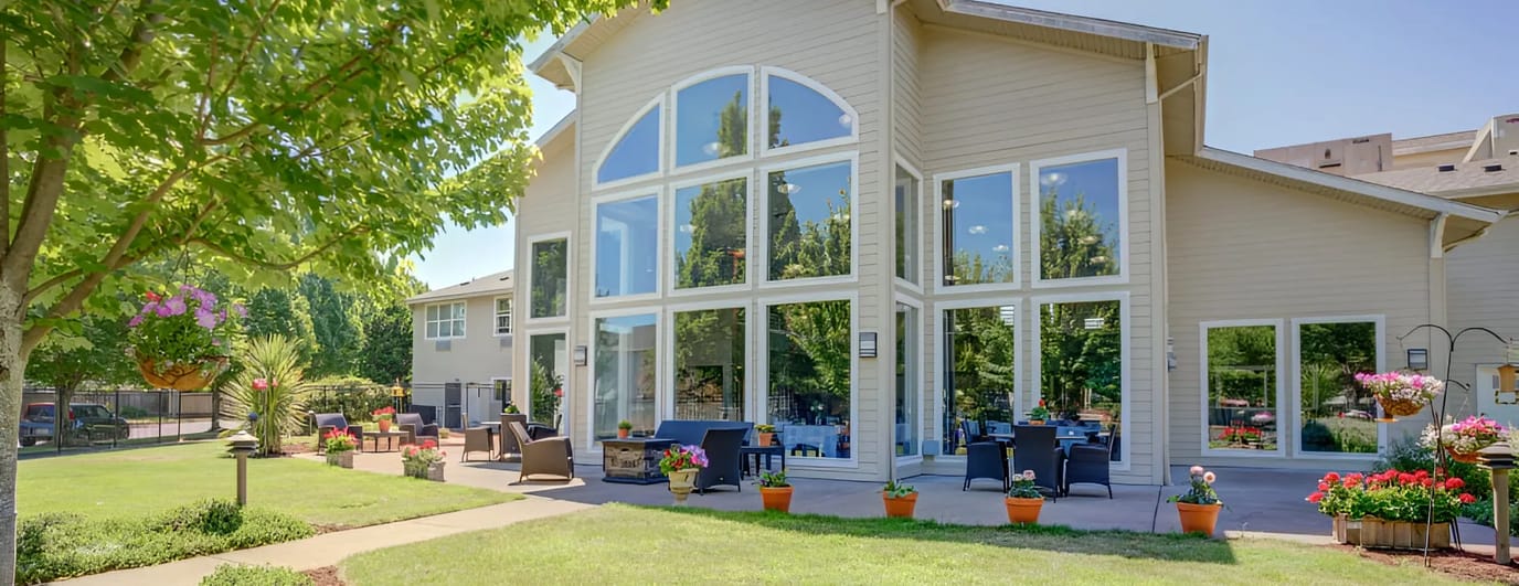 Exterior view of Evergreen Senior Living with outdoor seating area
