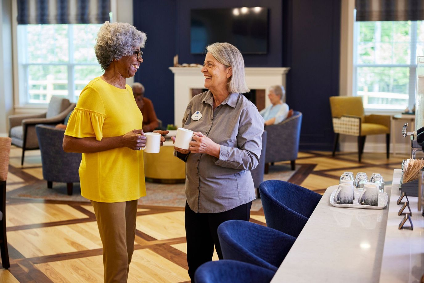 Residents and staff enjoying conversation in a common area