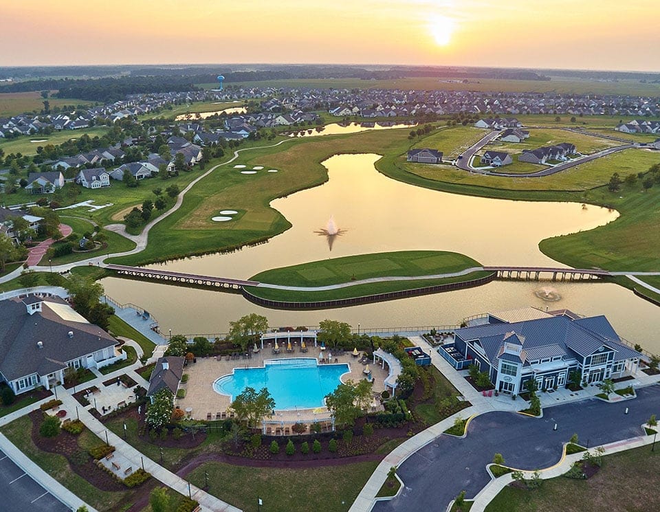 Aerial view of a swimming pool and lake at the facility