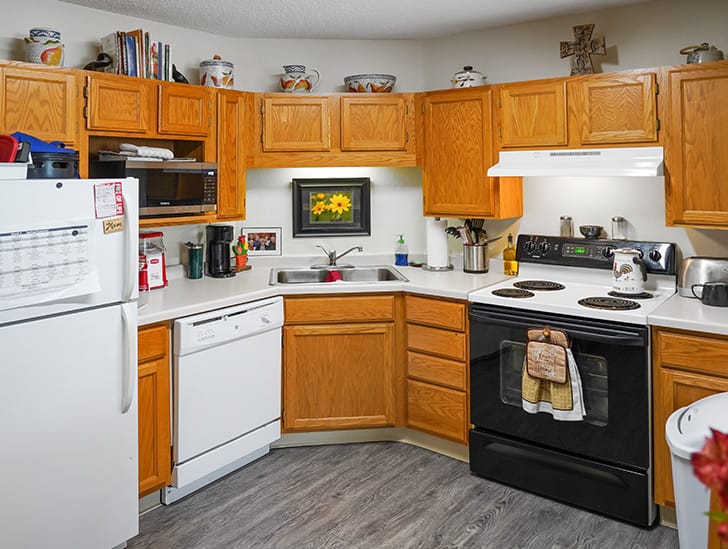 A modern kitchen interior with wooden cabinets and appliances