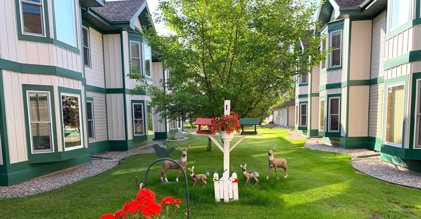 Courtyard with decorative deer statues and lush greenery