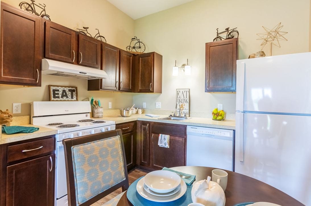 Modern kitchen with dark wood cabinets and dining table.