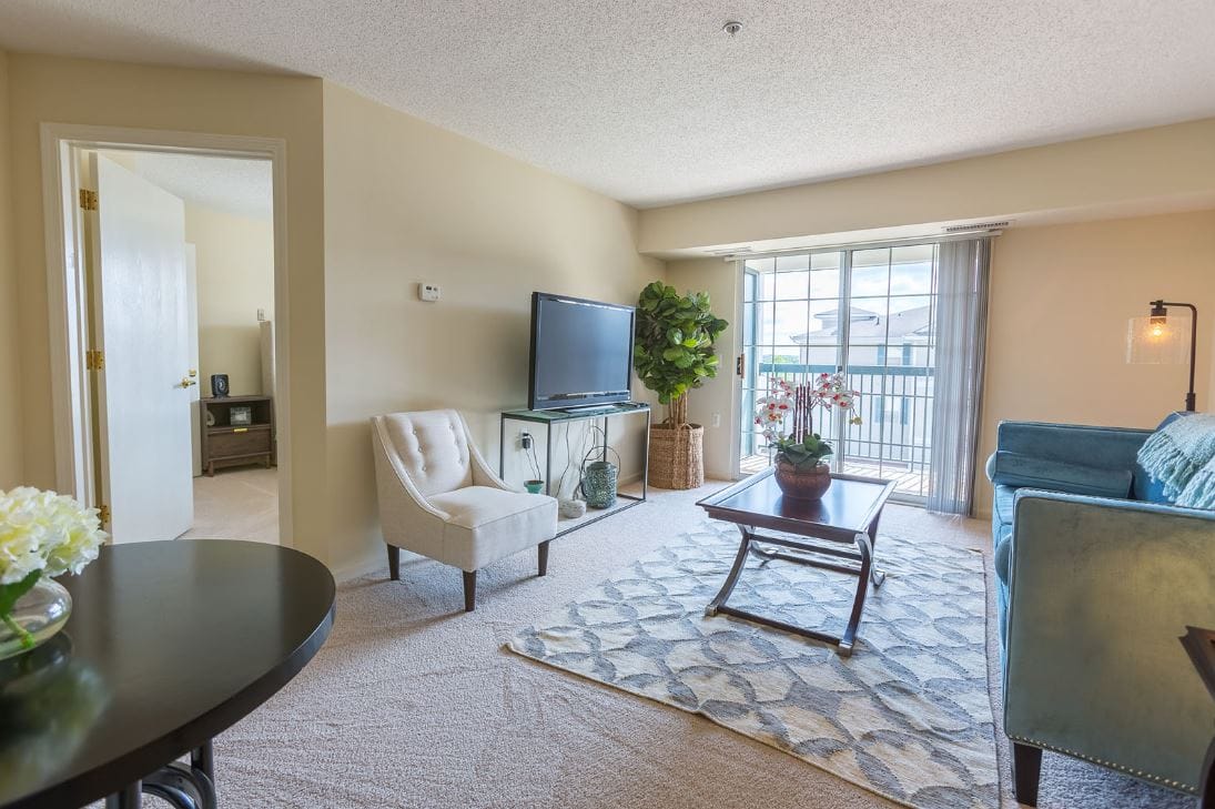 Comfortable living room with seating and balcony access