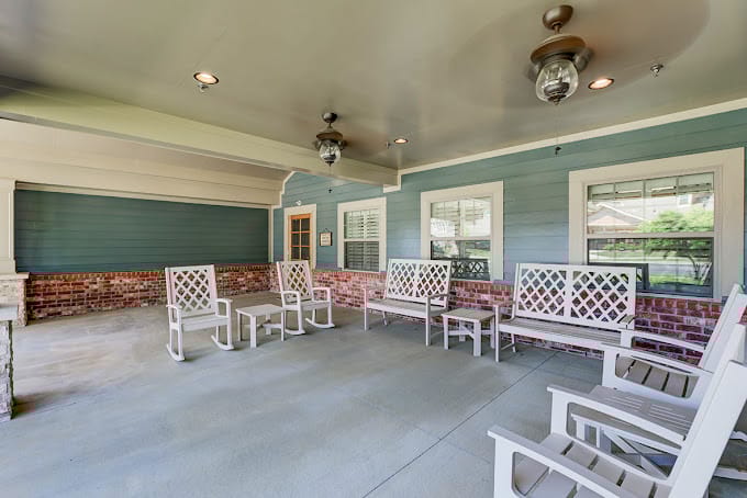 Spacious outdoor patio with white seating and blue walls