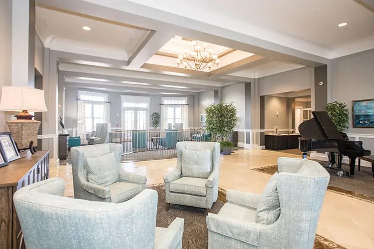 Spacious lobby with comfortable seating and a piano