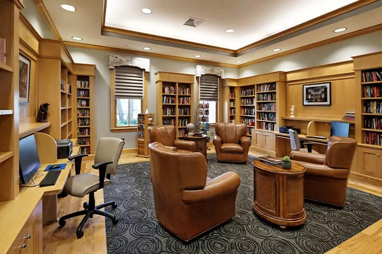 Inviting library space with bookshelves and comfortable seating.