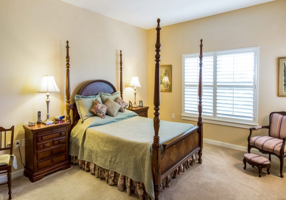 Well-furnished private resident room with a bed and seating