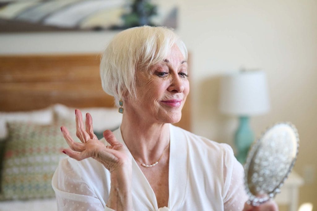 Senior woman enjoying her reflection in a mirror