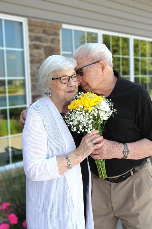 Couple enjoying time together outdoors with flowers