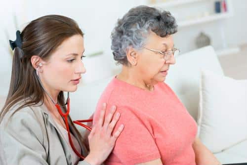 Nurse consulting with senior resident in a care facility
