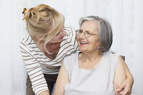 Caregiver interacting with a smiling resident