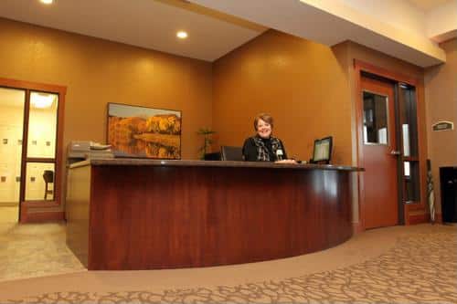 A receptionist at the front desk of a senior living facility