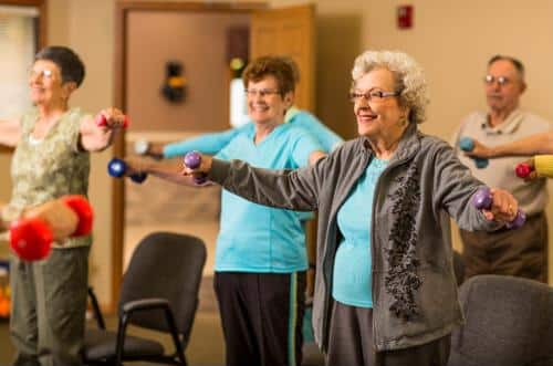 Residents participating in a group exercise class indoors
